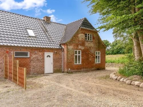 a red brick house with a white door at Apartment Geraldine - 3-5km to the fjord by Interhome in Spottrup