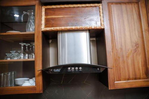 a stove top oven in a kitchen at Abbi Holidays - Jaffna Luxurious Villa in Jaffna