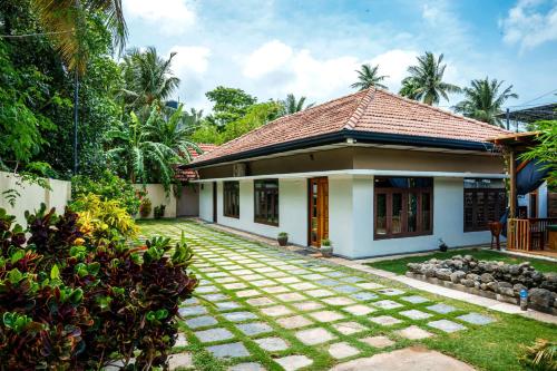 a small house with a tile roof at Abbi Holidays - Jaffna Luxurious Villa in Jaffna