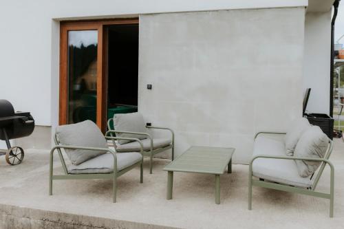 a group of chairs and a coffee table on a patio at Chata Stromček in Zuberec