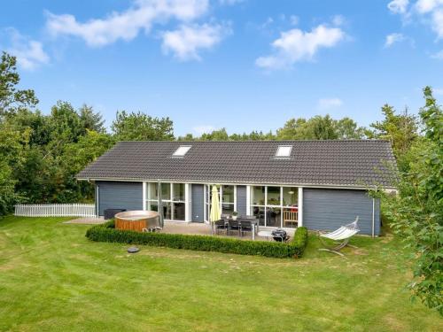 a small blue house with a yard at Holiday Home Nauka - 400m to the fjord by Interhome in Storvorde