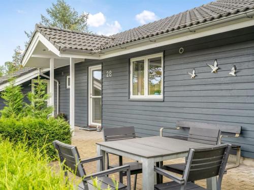 a table and chairs in front of a house at Holiday Home Nauka - 400m to the fjord by Interhome in Storvorde