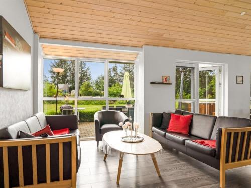 a living room with a couch and a table at Holiday Home Nauka - 400m to the fjord by Interhome in Storvorde