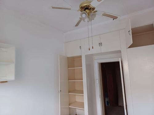 a ceiling fan in a room with white cabinets at 19 on Smit in Piet Retief