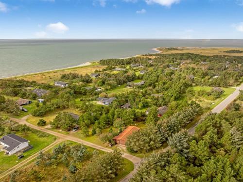 an aerial view of a home next to the ocean at Holiday Home Skrollan - 200m to the fjord by Interhome in Sindrup