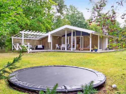 a house with a trampoline in the yard at Holiday Home Arto - 1-2km from the sea by Interhome in Vig