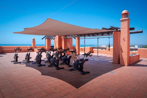 a group of people doing yoga in front of a building at Royal Hideaway Sancti Petri in Chiclana de la Frontera
