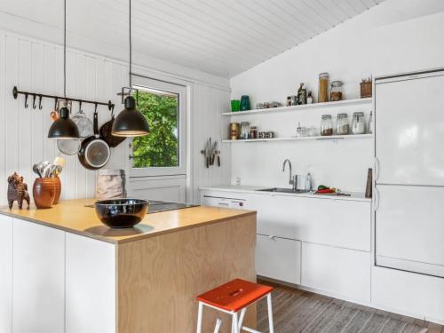 a kitchen with white cabinets and a wooden counter top at Holiday Home Arto - 1-2km from the sea by Interhome in Vig