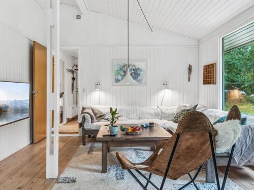 a living room with a table and a couch at Holiday Home Arto - 1-2km from the sea by Interhome in Vig