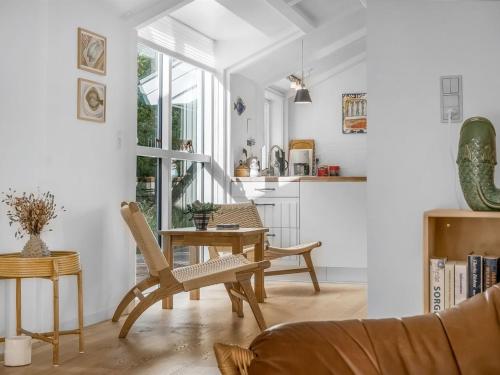 a living room with a table and chairs at Holiday Home Reinfried - 250m from the sea by Interhome in Jerup