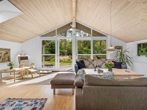 a living room with a couch and a table at Holiday Home Reinfried - 250m from the sea by Interhome in Jerup