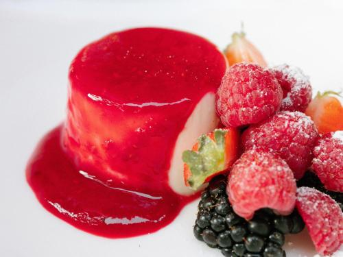 a pile of fruit with red sauce on a white plate at Royal Hideaway Sancti Petri in Chiclana de la Frontera