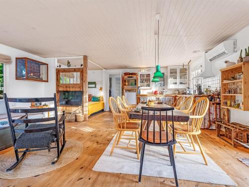 a kitchen and dining room with a table and chairs at Holiday Home Heraldine - 400m from the sea by Interhome in Stubbekøbing