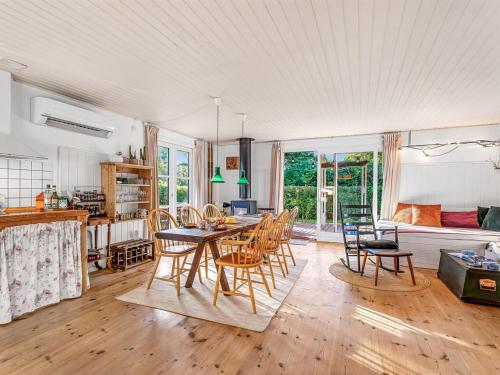 a kitchen and dining room with a table and chairs at Holiday Home Heraldine - 400m from the sea by Interhome in Stubbekøbing