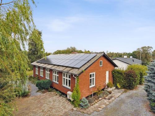 a red brick house with a solar roof at Holiday Home Saja - 550m from the sea by Interhome in Børkop