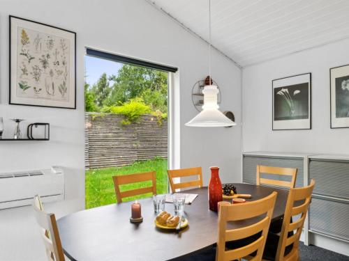 a dining room with a table and chairs and a window at Holiday Home Franke - 2-1km to the inlet by Interhome in Melby