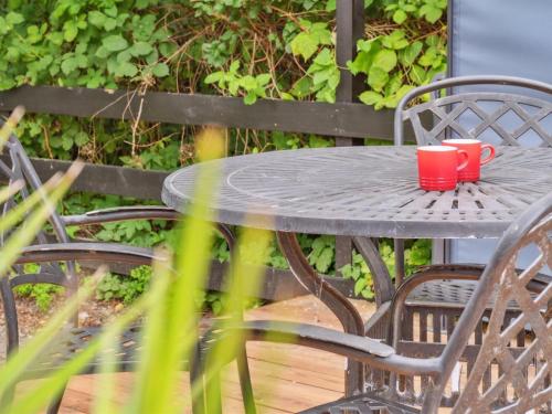 a table with two red cups on top of it at Holiday Home Franke - 2-1km to the inlet by Interhome in Melby