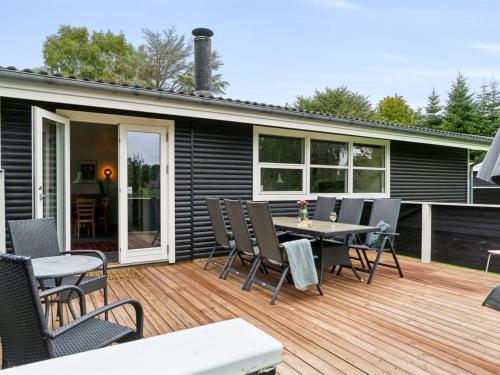 a patio with a table and chairs on a deck at Holiday Home Franke - 2-1km to the inlet by Interhome in Melby