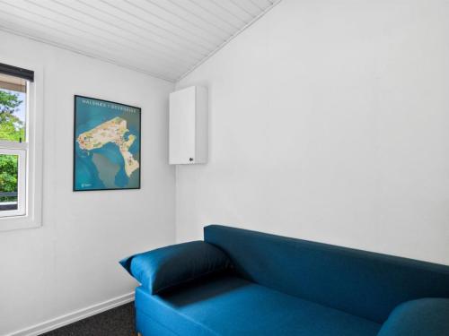 a blue couch in a living room with a window at Holiday Home Franke - 2-1km to the inlet by Interhome in Melby