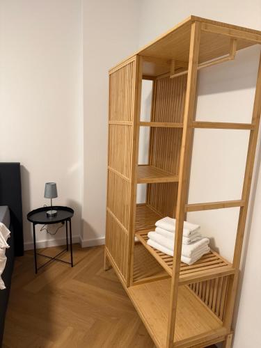 a book shelf with folded towels in a room at Pension Marie Prenzlauer Berg in Berlin