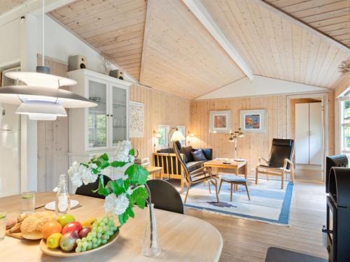 a dining room and living room with a table at Holiday Home Zezilie - 125m from the sea by Interhome in Gørlev