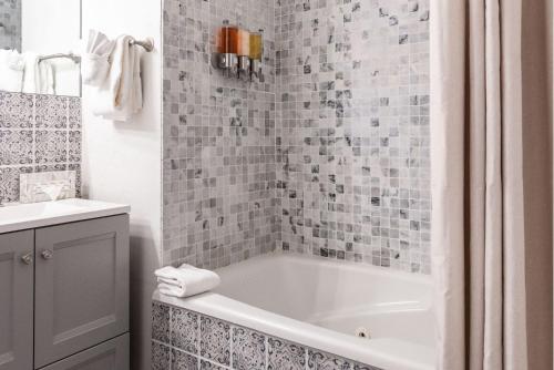 a bathroom with a bath tub and a sink at The Alpenhof in Teton Village