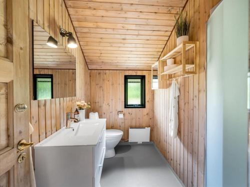 a bathroom with a white sink and a toilet at Holiday Home Regine - 1-1km to the inlet by Interhome in Oksbøl