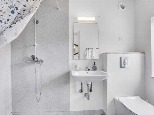 a white bathroom with a shower and a sink at Holiday Home Aleta - 300m from the sea by Interhome in Fakse Ladeplads