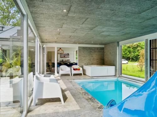 a house with a swimming pool and a patio at Holiday Home Aviana - 500m from the sea by Interhome in Glesborg