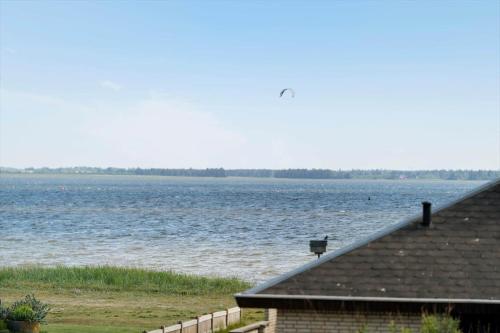 a house with a view of a large body of water at 70751-Ulfborg-Fjordvaenget-13 in Thorsminde