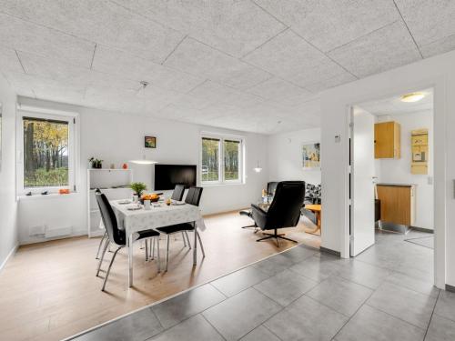 a dining room and living room with a table and chairs at Apartment Kamp - 1km to the fjord by Interhome in Ringkøbing