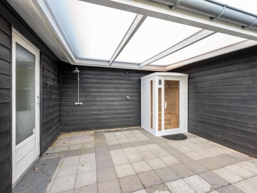 an empty room with a skylight in a house at Holiday Home Billa - 450m from the sea by Interhome in Blåvand