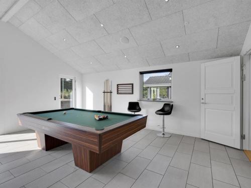 a pool table in a room with a ceiling at Holiday Home Billa - 450m from the sea by Interhome in Blåvand