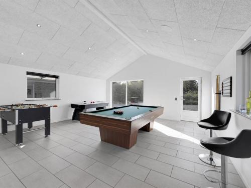 a large room with a pool table and two tables at Holiday Home Billa - 450m from the sea by Interhome in Blåvand