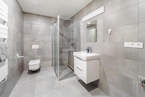a bathroom with a toilet sink and a shower at Wellness apartmán Pila Kvilda in Kvilda