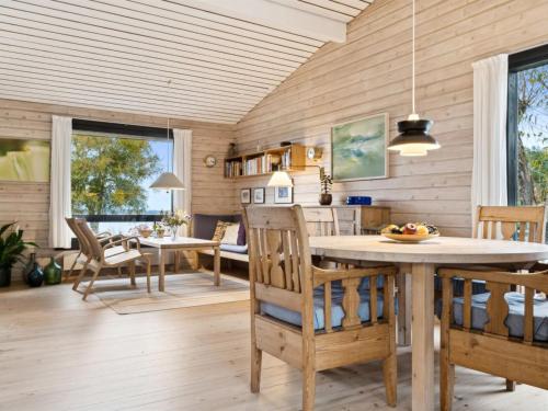 a kitchen and dining room with a table and chairs at Holiday Home Adelbert - 600m to the inlet by Interhome in Jægerspris
