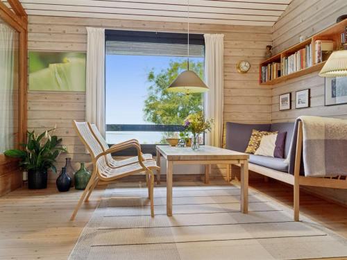 a living room with a table and a couch at Holiday Home Adelbert - 600m to the inlet by Interhome in Jægerspris