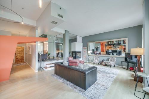 a living room with a couch and a table at Dtwn Cleveland Loft-Style Condo Walk to Stadiums! in Cleveland