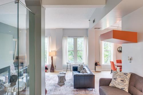 a living room with a couch and a chair at Dtwn Cleveland Loft-Style Condo Walk to Stadiums! in Cleveland