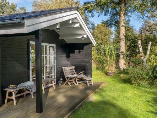 a patio with two chairs on a deck at Holiday Home Evi - 500m from the sea by Interhome in Jerup
