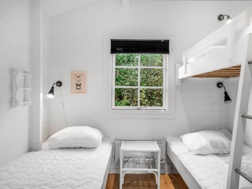 a bedroom with two beds and a window at Holiday Home Evi - 500m from the sea by Interhome in Jerup