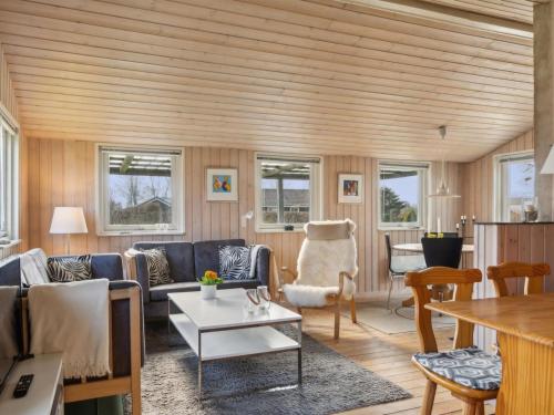 a living room with a couch and a table at Holiday Home Bjarni - 175m from the sea by Interhome in Malling