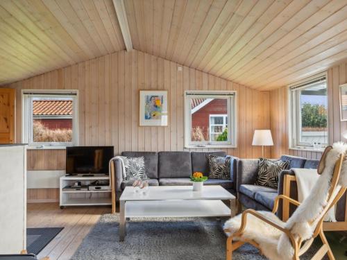 a living room with a couch and a table at Holiday Home Bjarni - 175m from the sea by Interhome in Malling