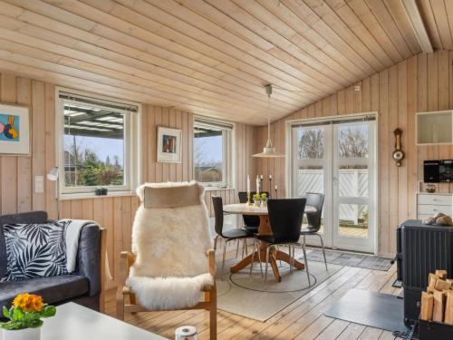 a living room with wooden walls and a wooden ceiling at Holiday Home Bjarni - 175m from the sea by Interhome in Malling