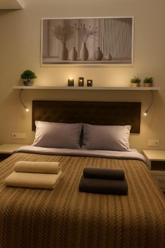 a bedroom with a large bed with two pillows on it at Annabelle Studio in Batumi