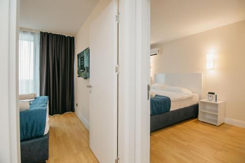 a hotel room with a bed and a window at Batumi River Source in Batumi