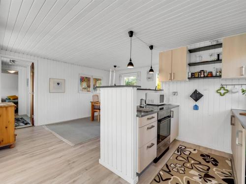 a kitchen with white cabinets and a counter top at Holiday Home Pirjo - 350m to the fjord by Interhome in Skjern