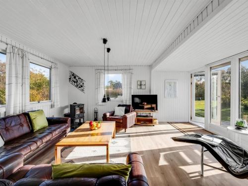 a living room with a couch and a table at Holiday Home Pirjo - 350m to the fjord by Interhome in Skjern