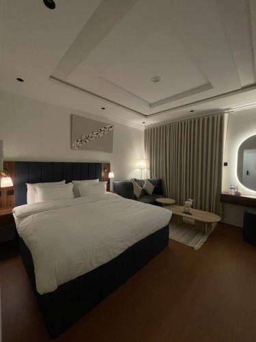 a hotel room with a large bed and a couch at Modern Studio in Al Malqa Riyadh Near to KAFD-Blvd in Riyadh
