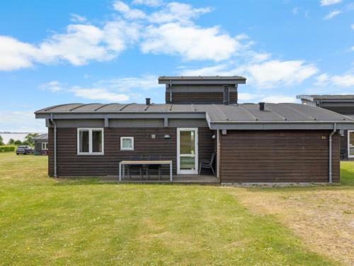 a log cabin with a large yard at Holiday Home Wilmar - 380m from the sea by Interhome in Nabbe